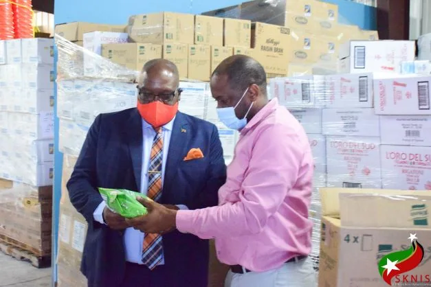 Gurdip Dev Bath inspecting donated dry food supplies during the pandemic relief initiative